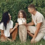 A joyful family enjoying time together in a lush green field.